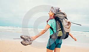 Girl backpacker traveler enjoys with fresh ocean wind