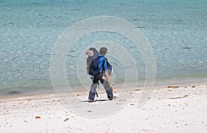Girl backpacker walking on a beach