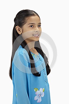 Girl in baju kurung smiling. Conceptual image