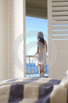 Girl on balcony looking at sea