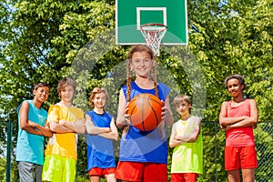 Girl with ball and international friends behind