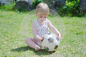 Girl with ball on lawn