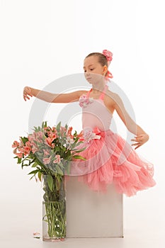 Girl ballerina in a tutu with flowers