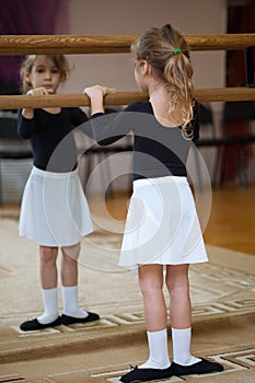 Girl at ballet barrel. Ballet pas. photo