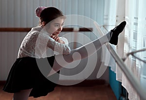 Girl ballet dancer practicing on the barre