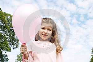 Girl with balloon in park.
