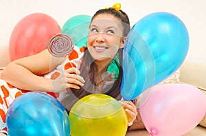 Girl with balloons and bonbon photo