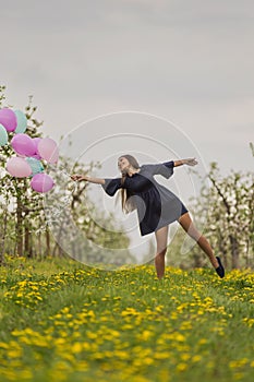 girl with balloons in the field
