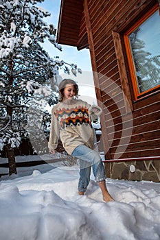 Girl barefoot runs in the snow. Winter sunny day. Hardening