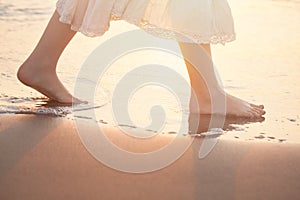 Girl Barefoot are Walking on the Beach in Water