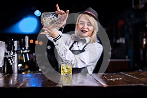 Girl barman concocts a cocktail at the pothouse