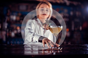 Girl barman concocts a cocktail on the saloon