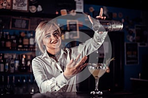 Girl bartender concocts a cocktail in the brasserie