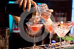 The girl bartender prepares a cocktail in the nightclub