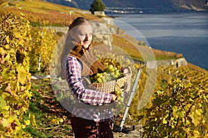 Girl with a basket full of grapes