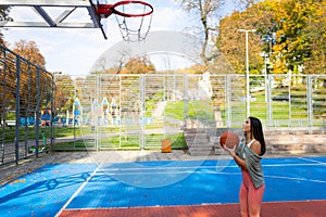 Girl basketball player getting ready to make a ball throw to the basket.