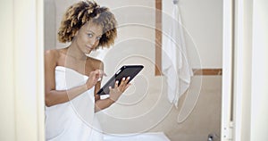 Girl In Bath Towels Using Touchpad photo