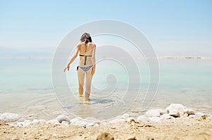 Girl bathe in Dead Sea