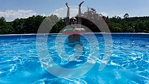 girl bathing with float and jumping