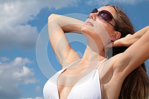 Girl in bathing suit and sunglasses