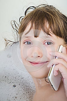 The girl in a bathroom calls by telephone