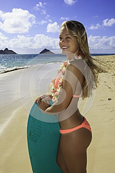 Girl on the beach with boogie board