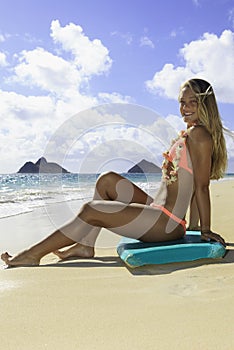 Girl on the beach with boogie board