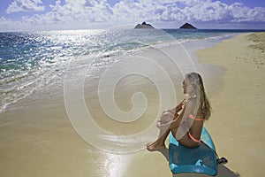 Girl on the beach with boogie board