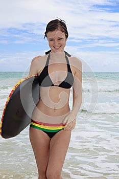 Girl at the beach with a boogieboard