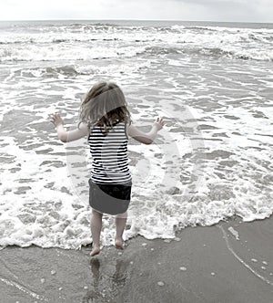 Girl at beach jumping in the waves