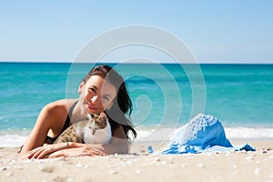 Girl on the beach with a kitten