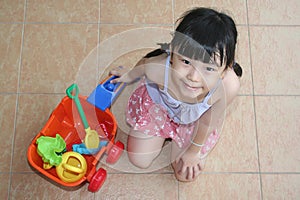 Girl with beach playset