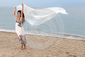 Girl on beach with scarf