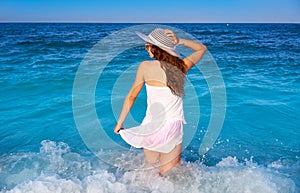 Girl in beach sea shore with waves splash