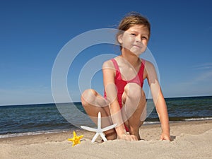 Girl on the beach with starfishes