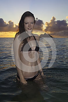 Girl on beach at sunrise