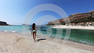 girl on a beach with turquoise clear waters