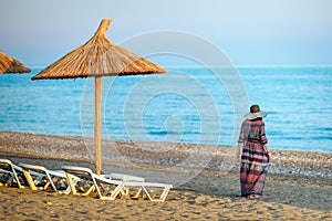 Girl on a beach, under an beach umbrella