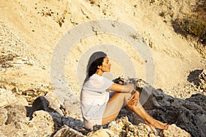 Girl on the beach watching the sunset