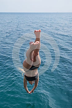 Girl plunging into deep sea water photo