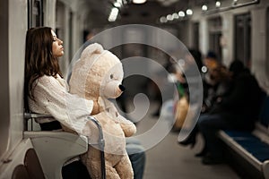 Girl with bear in a subway car. photo