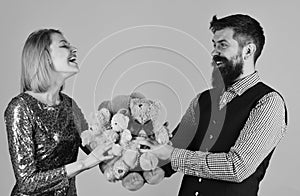Girl and bearded man with cheerful faces play with toys