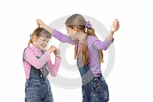 A girl beats another girl on the head