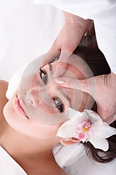 Girl and beautician. Facial massage. photo