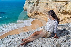 Girl at beautiful beach Carvalho of Algarve, Portugal photo