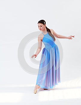 girl beautiful dress is engaged in dancing in the studio