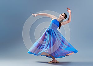 girl beautiful dress is engaged in dancing in the studio