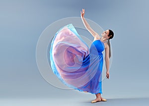 girl beautiful dress is engaged in dancing in the studio