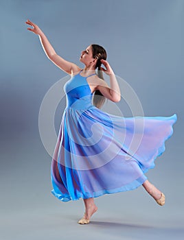 girl beautiful dress is engaged in dancing in the studio