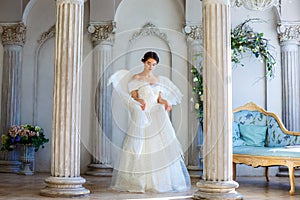 A girl in a beautiful dress and white wings of an angel inspires